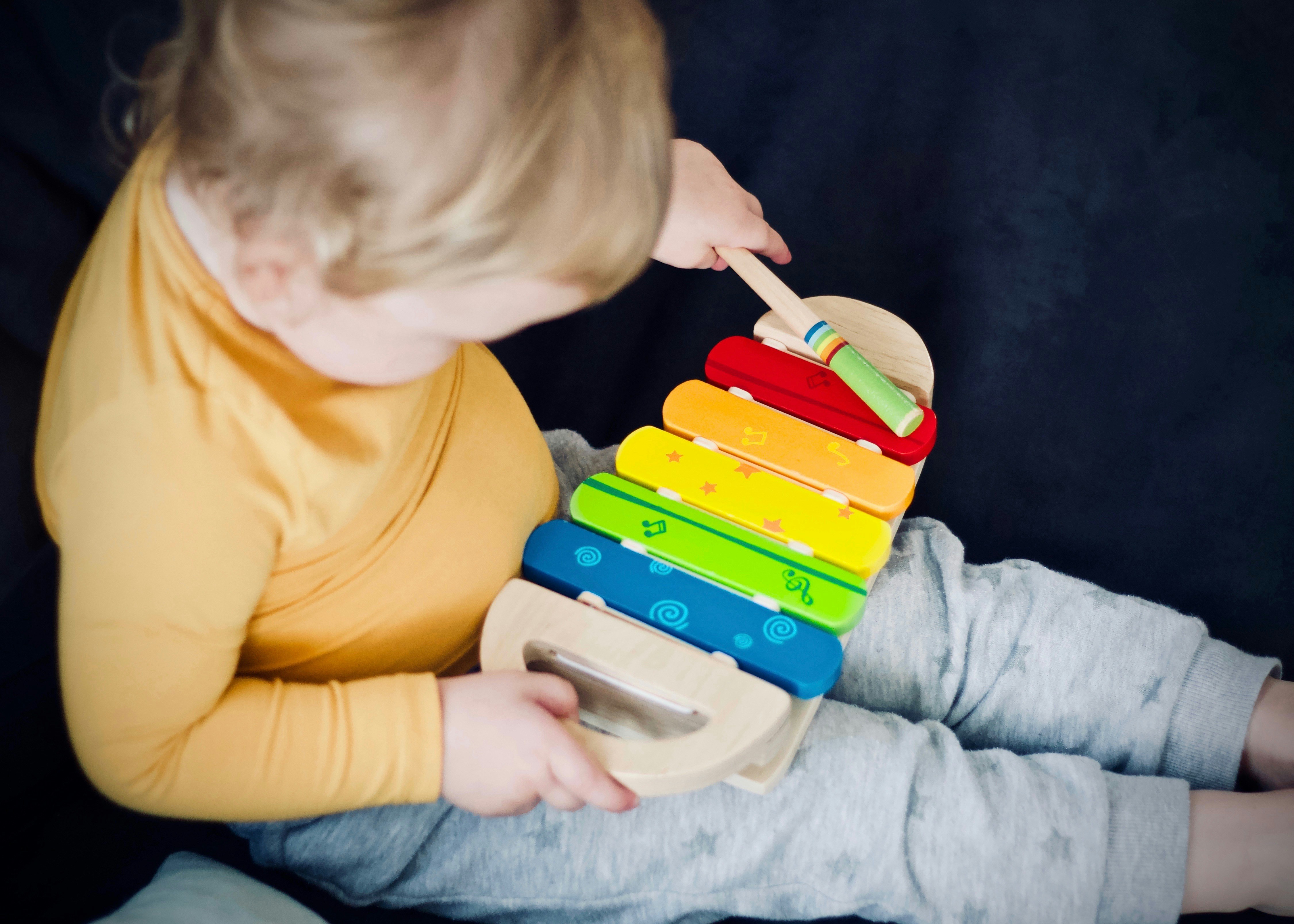 Child painting with colorful hands